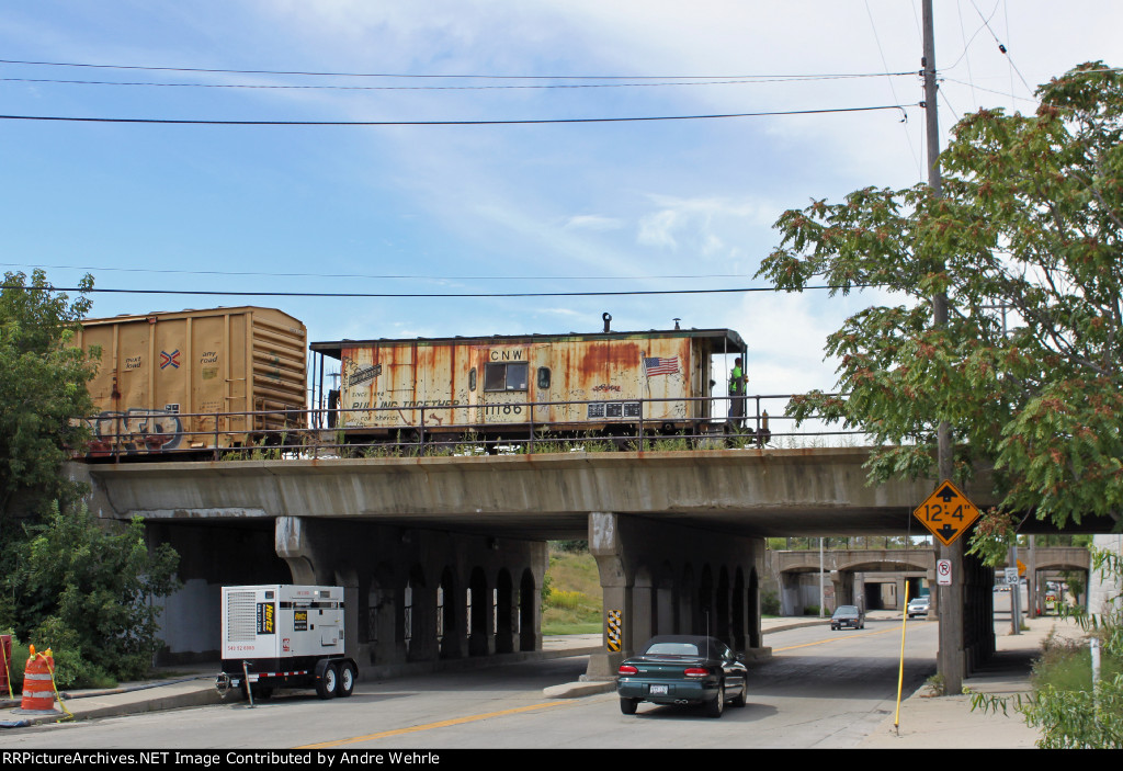 CNW 11186 is shoved across the National Ave. bridge